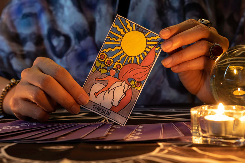 fortune teller holding sun card