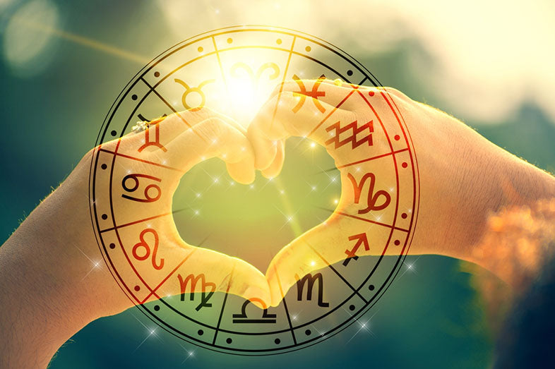hands making heart shape over zodiac signs
