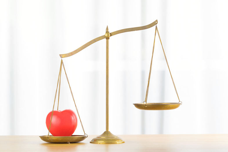 justice weight scale holding apple