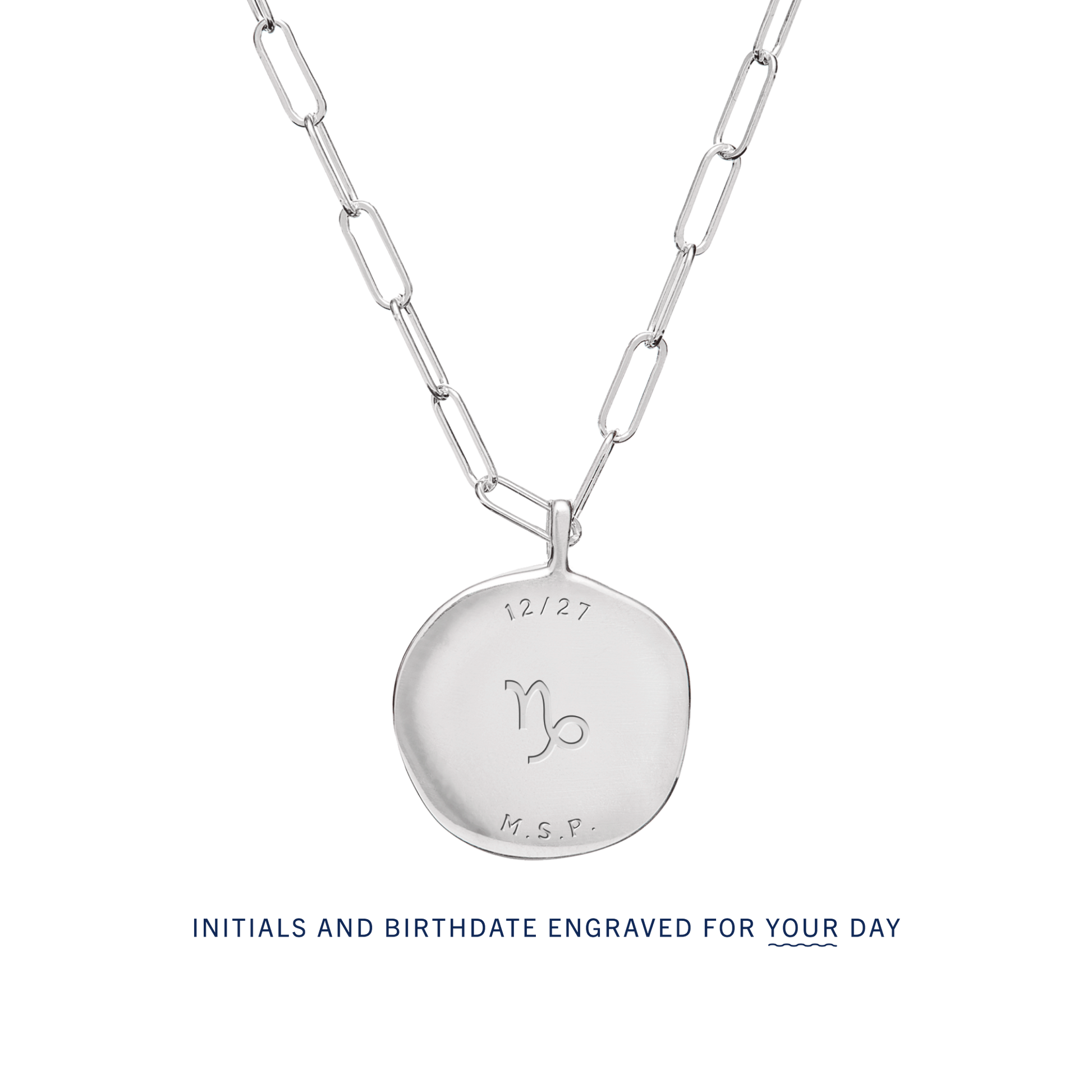 The back of a Birthdate Pendant with sample engraving. Initials and birthdate can be custom engraved for your day.
