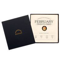 The February Twenty-First Pendant inside its box